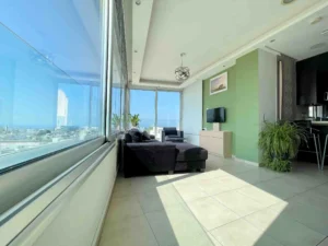 Luxurious living room with panoramic windows showcasing morning views of Ayia Napa bay, Cyprus.