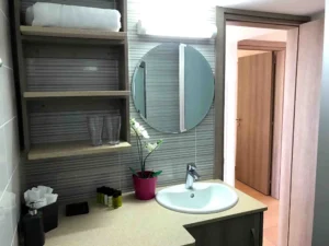 A tastefully designed Ayia Napa bathroom that balances function and flair with a touch of greenery.