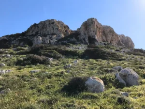 Rocky hills and green meadows at Cape Greco near Ayia Napa, Cyprus, exemplifying a peaceful retreat at Topikos Apartments.