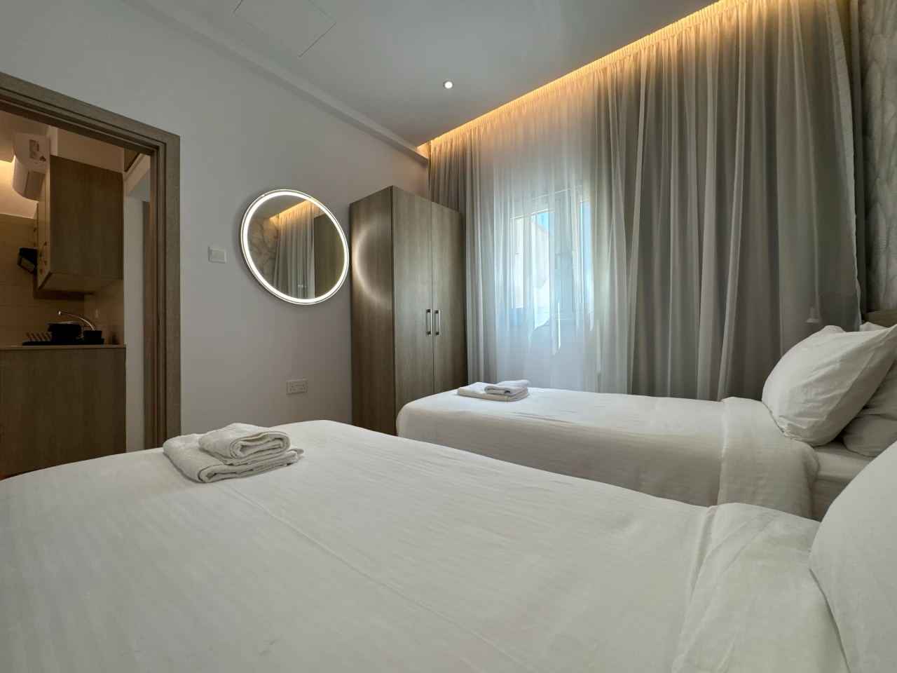 Another view of the comfortable twin bedroom with two single beds in the Central Charming Apartment with Balcony Sea View, Ayia Napa, Cyprus.