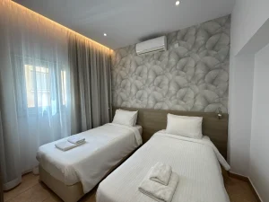 Comfortable twin bedroom with air conditioning in the Charming Central Apartment with Sea View Balcony, Ayia Napa, Cyprus.