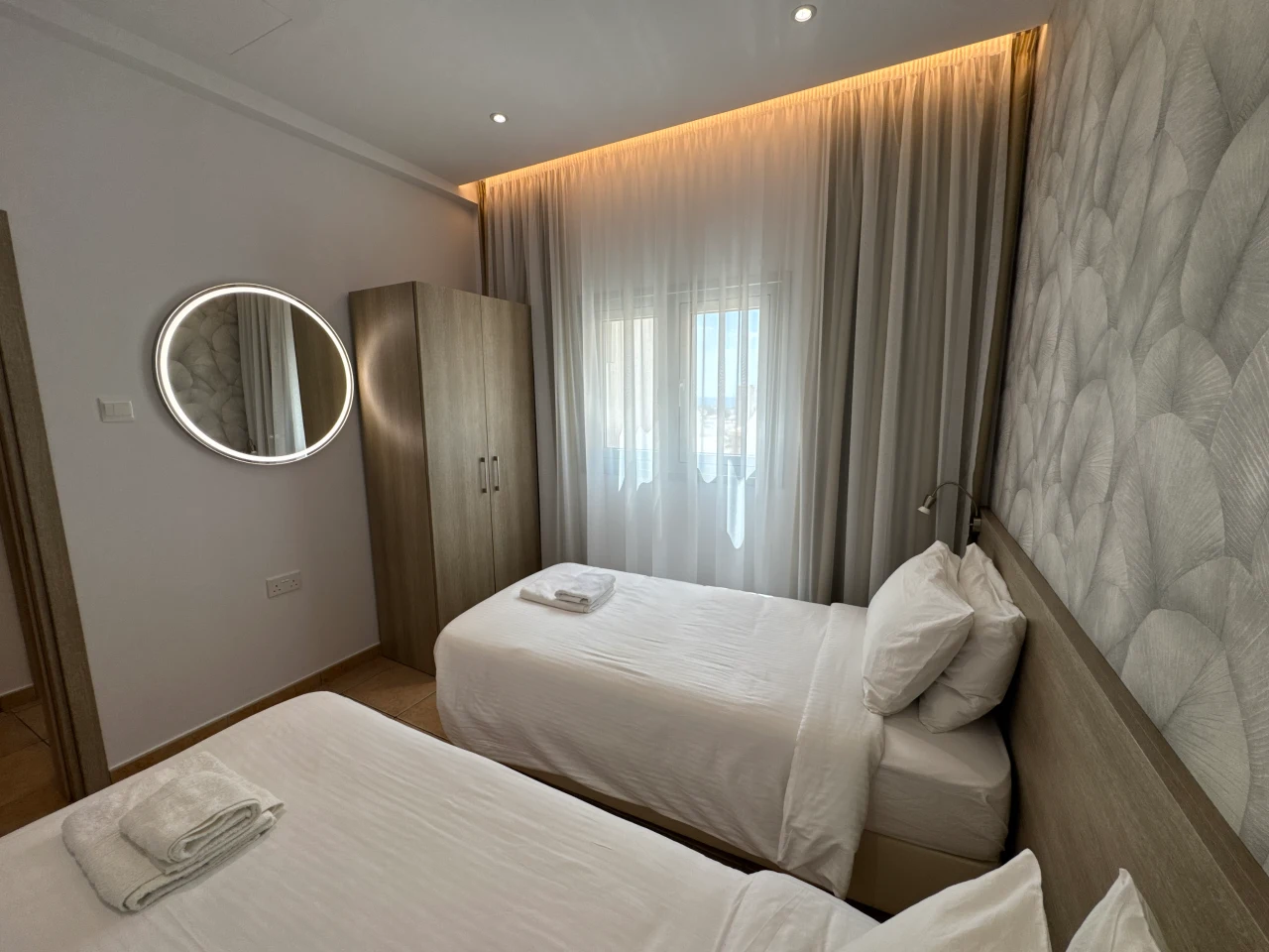 Comfortable twin bedroom with two single beds in the Charming Central Apartment with Sea View Balcony, Ayia Napa, Cyprus.