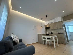 Another view of the comfortable living area, dining table, and modern kitchen in our holiday apartment in Ayia Napa, Cyprus.